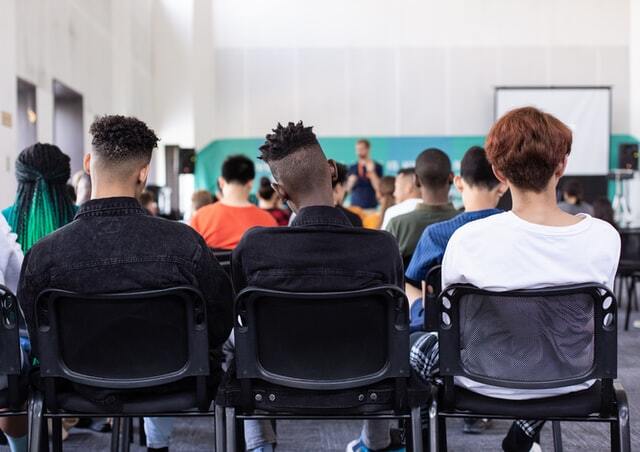 Teilnehmer einer Schulung vor Seminarleiter